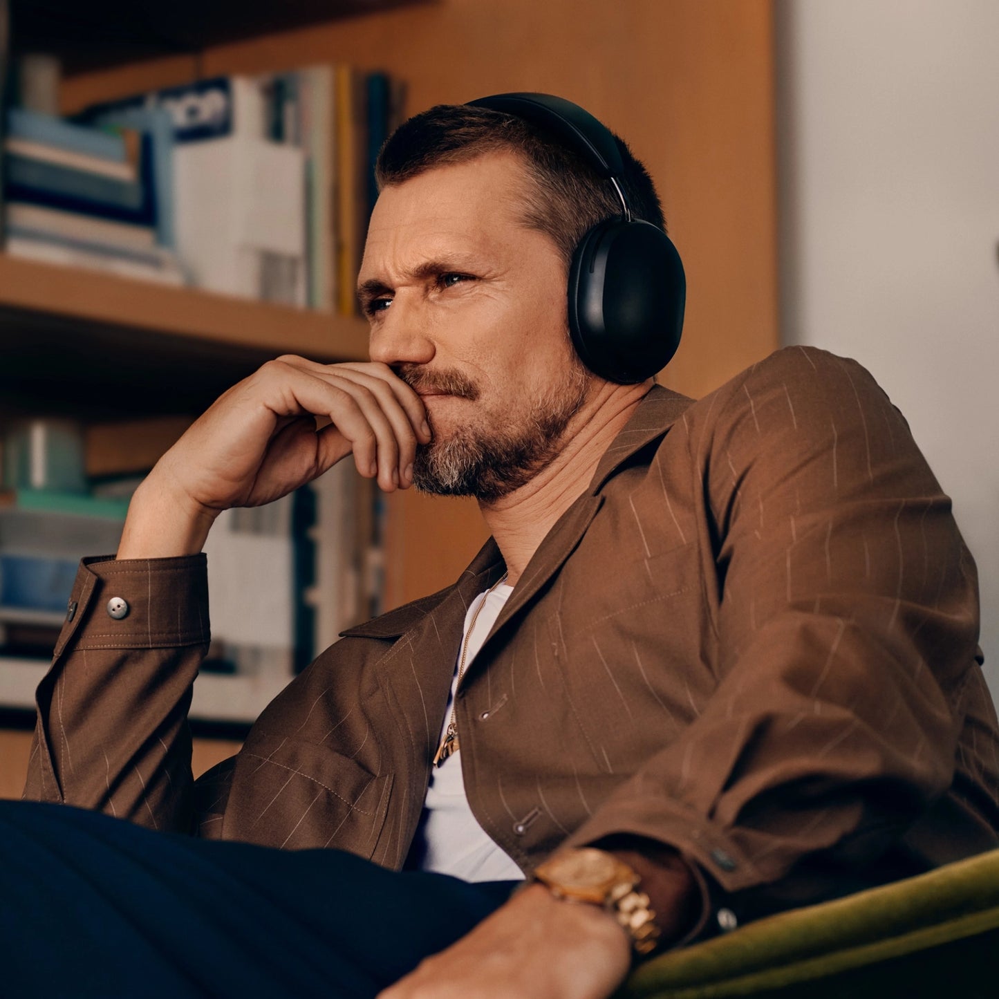 White man listening to music with the  black sonos ace